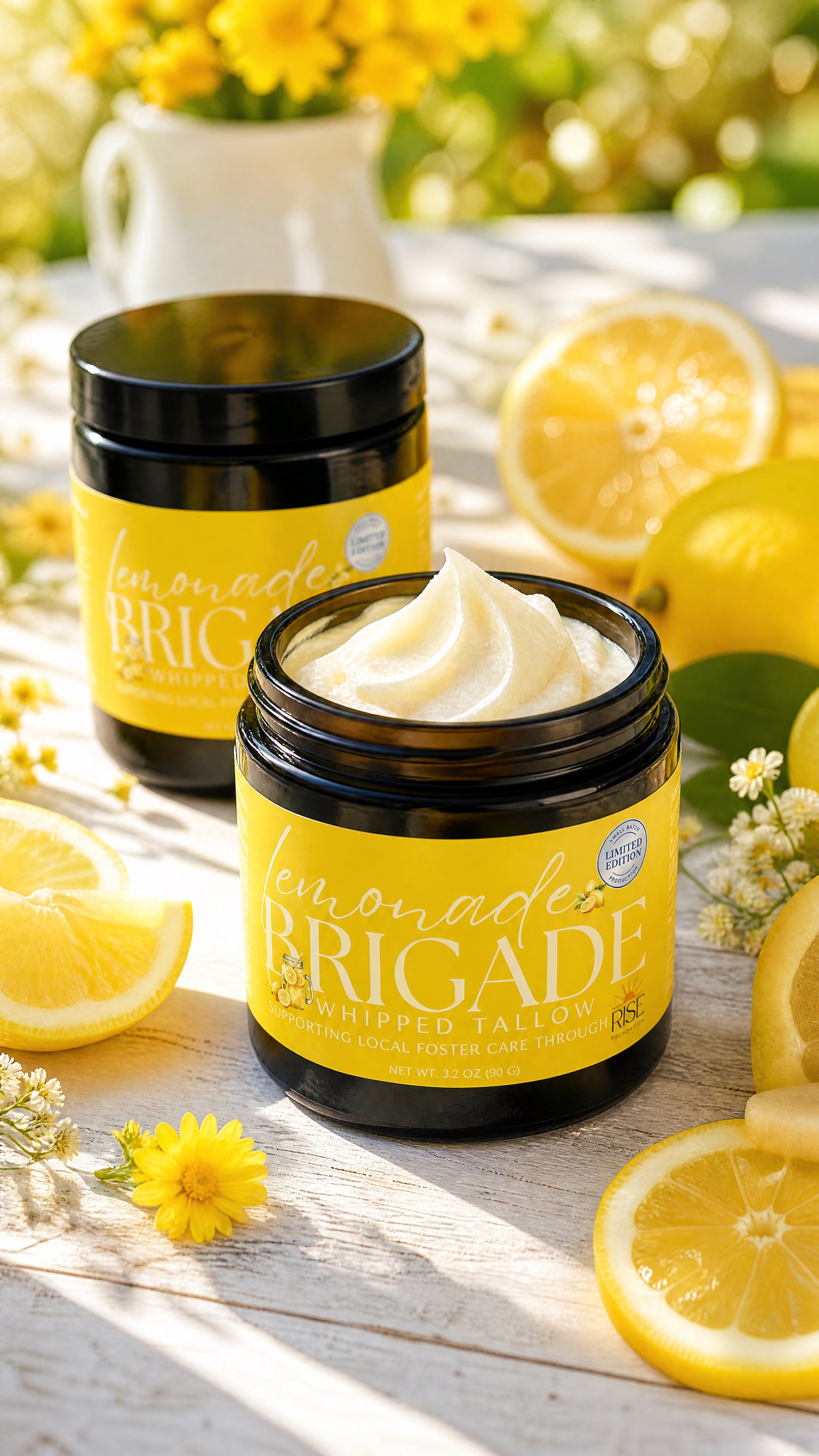 Two Lemonade Brigade Whipped Tallow jars in warm golden light